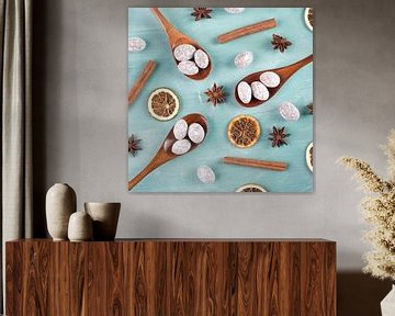 Spiced almonds with anise stars and cinnamon on blue background by Berit Kessler
