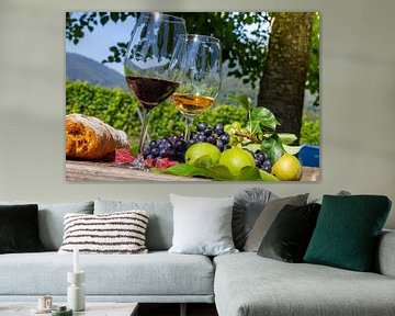 Ripe grapes decorated with wine glasses on a wooden table in the Palatinate region of Germany by Udo Herrmann