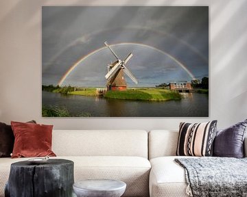 grote dubbele regenboog boven Nederlandse windmolen in zomerregen van Olha Rohulya