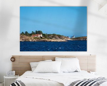 Rocky coast and lighthouse Hamborsund Fyr in Norway