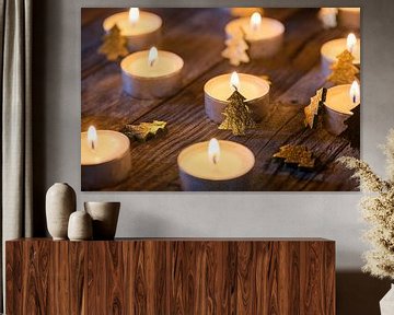 Christmas candlelight ornate with golden xmas trees on wooden table by Alex Winter