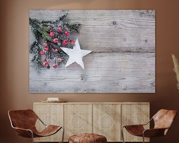 Christmas star with natural fir tree branch and red berries decoration on wood background by Alex Winter