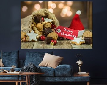 Christmas food and sweets with red santa hat and with tag text Merry Christmas by Alex Winter