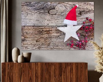 Weihnachts- oder Adventsdekoration mit Holzstern, Weihnachtsmannmütze und roten Beeren von Alex Winter