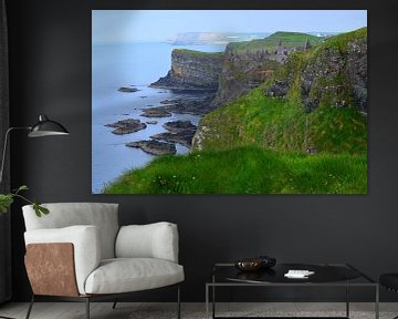 Green, rugged Northern Ireland coastline with mysterious castle ruins by Studio LE-gals