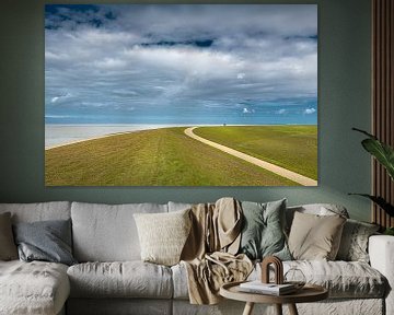 The Frisian Waddendijk with a single cyclist on the horizon by Harrie Muis