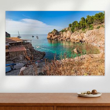 Beautiful view of Cala Deia beach with anchoring boats at bay