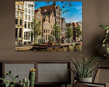 House facades and street boats on a canal canal in Amsterdam Netherlands by Dieter Walther