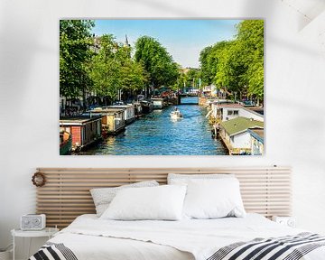 Trees and houseboats at canal in Amsterdam city center in Netherlands by Dieter Walther