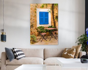View of idyllic patio of mediterranean house with blue window shutters by Alex Winter