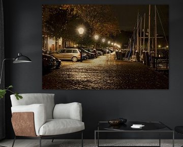 Parked cars in nocturnal Veere, beautifully lit on a shiny street by Gert van Santen