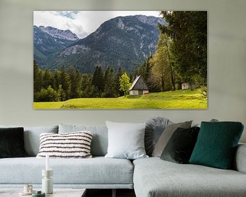 Mountain hut in front of high mountains in Slovenia by Robert Ruidl