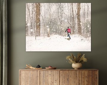 Man met rode rugtas in de sneeuw van Herman Heus