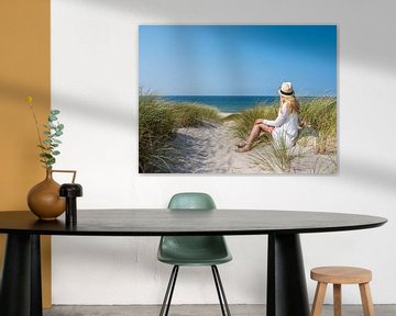 junge Frau sitzt in den Dünen auf Sylt an der Nordsee von Animaflora PicsStock