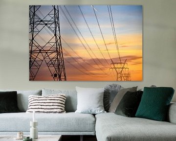 High Voltage electricyty transmission towers during sunset 