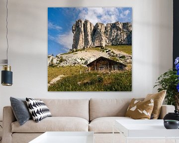 Wooden barn under steep rock face in the Swiss Alps by Steven Van Aerschot