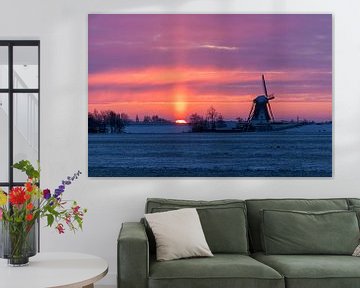 Traditional windmill in wintry landscape at sunrise by Ruurd Dankloff