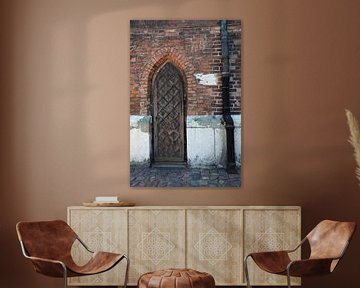 Narrow door in center of Gdansk, Poland by Joost Adriaanse