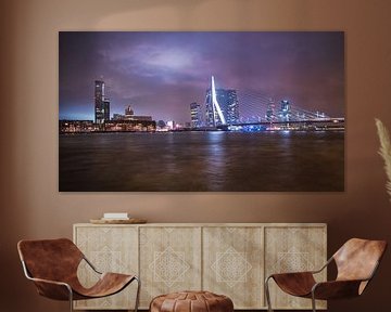 City view of Rotterdam and the Erasmus Bridge taken on a rainy evening in Rotterdam Netherlands.