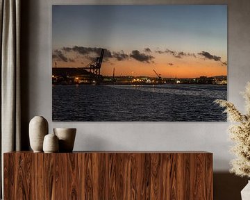 Sunset over the harbor of Valletta, Malta with sea cranes and an