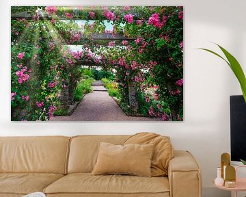 Pink roses entwined around pavilion on summer day by pixxelmixx