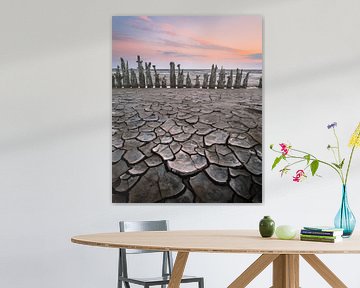 Weathered poles on the Wadden Sea | Landscape photography with pastel shades by Marijn Alons