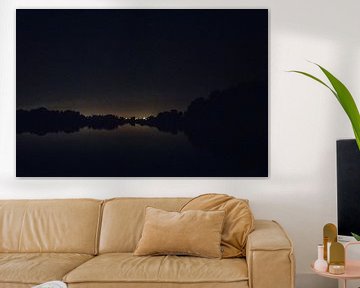 Reflection of lights in a dark lake at night - nature photography print by Laurie Karine van Dam