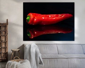 Dot bell pepper on black mirror background by Arjan van der Veer