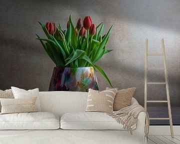 Still life with tulips in a colored glass vase