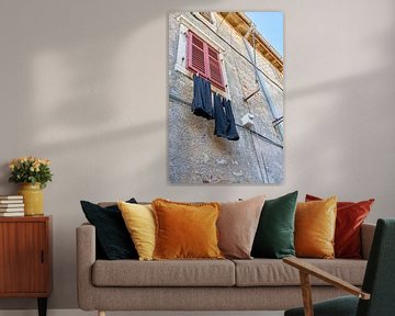 Clothesline with pants on a facade in the old town of Krk by Heiko Kueverling