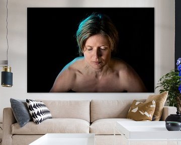 Low key studio portrait of a 35 year old white woman with naked