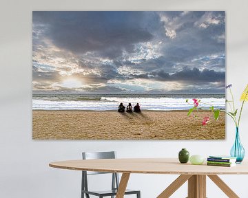 Three women on the beach with clouds and sunset by Dieter Walther