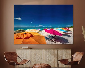 Colorful parasols on the beach of Aruba in the Caribbean.