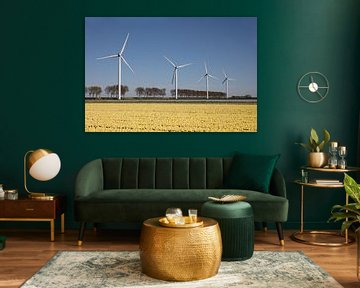 Yellow tulip field with wind turbines on the horizon by W J Kok