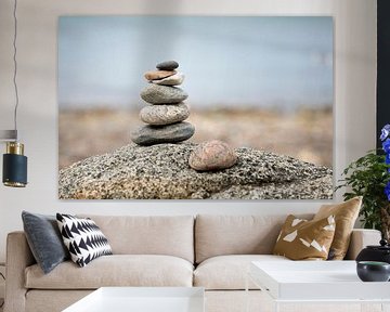 stones stacked on top of each other with a blue green sea by Karijn | Fine art Natuur en Reis Fotografie