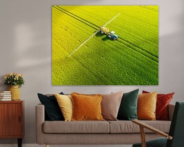 Tractor with an agriculutural crops sprayer from above by Sjoerd van der Wal